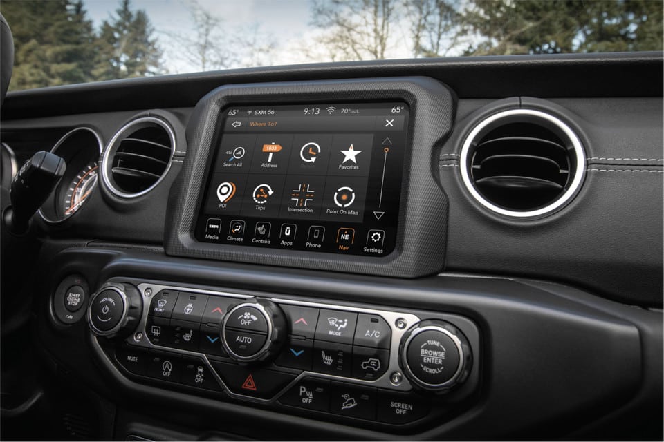 Car dashboard with touchscreen navigation system displaying GPS and control options.