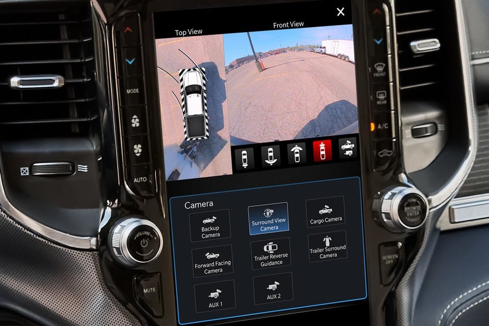 Car dashboard screen displaying a surround view camera system with multiple viewing options and controls.