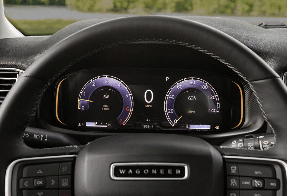 Car dashboard with digital speedometer and tachometer, displaying 0 MPH and 1963 miles.