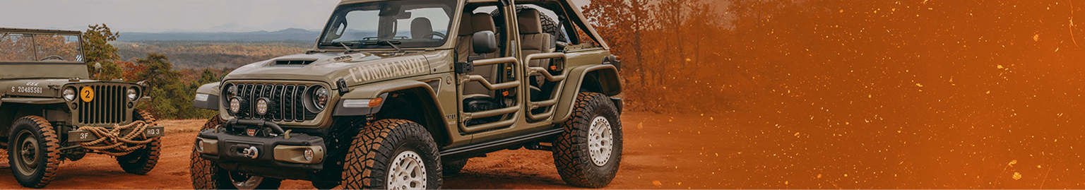 Two rugged off-road vehicles parked outdoors on a dirt path, with an orange filter effect.