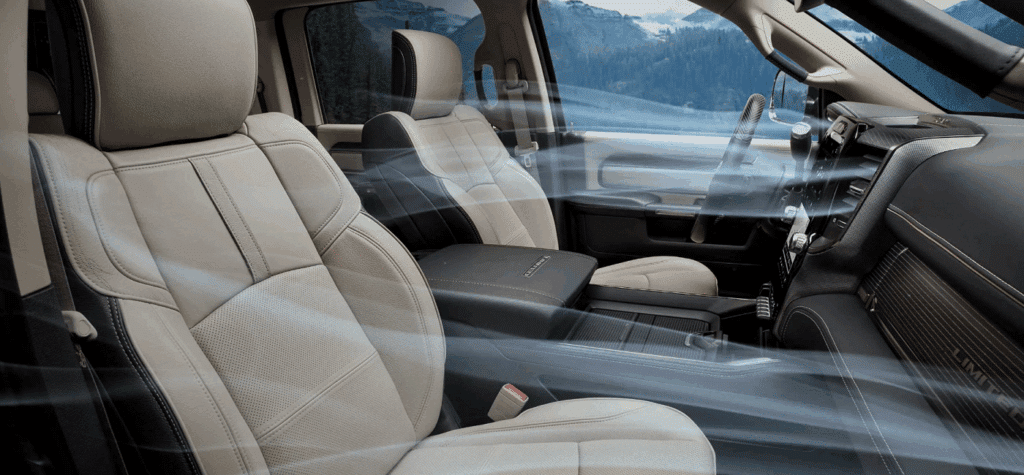Luxurious car interior with beige leather seats and visible air conditioning airflow, showcasing comfort features.